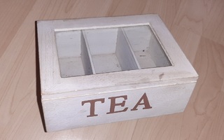 Valkoinen teelaatikko ruskea teksti TEA