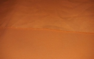 Kangas : oranssi asustekangas 95x142cm