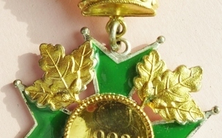Mitali arvomerkki kullanvärinen ja kruunu päällä, käytetty