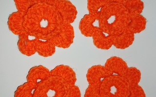 Neljä oranssia virkattua kukkasta
