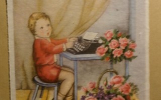 Taapero kirjoituskoneella onnittelutekstiä kera kukkien, k.